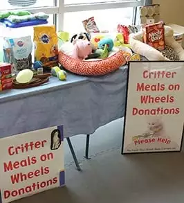 a table full of a drvie for pet food and toys: Community Involvement in Peoria